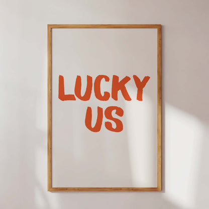 Framed artwork with 'LUCKY US' text on a white wall