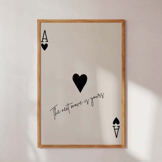 Framed artwork with playing card symbols and text on a white wall