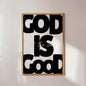 Framed poster with 'GOD IS GOOD' text on a light background