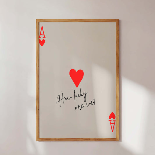 Framed artwork with red hearts and text on a white wall