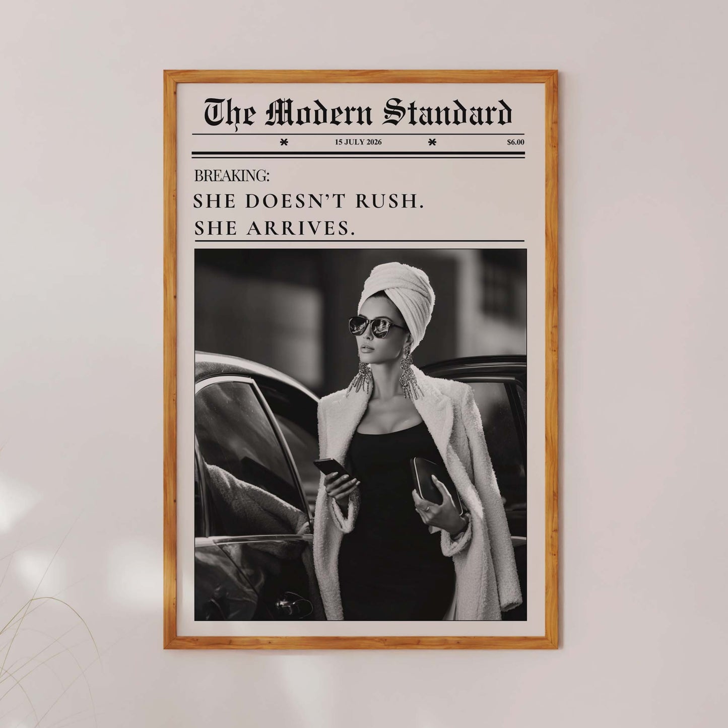 Framed poster of a woman in a car with text on a white wall.