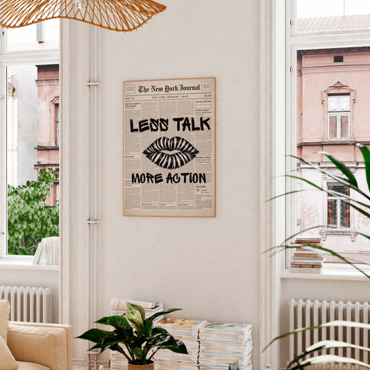 Framed poster with 'Less Talk, More Action' quote in a living room setting.