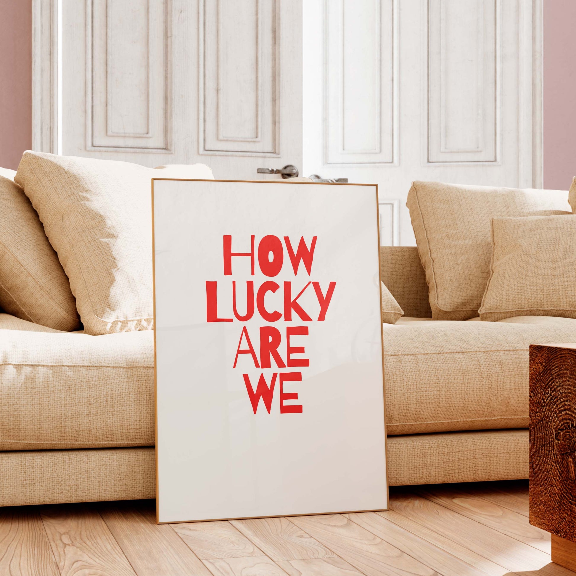 Sofa with a 'How Lucky Are We' sign in a living room setting