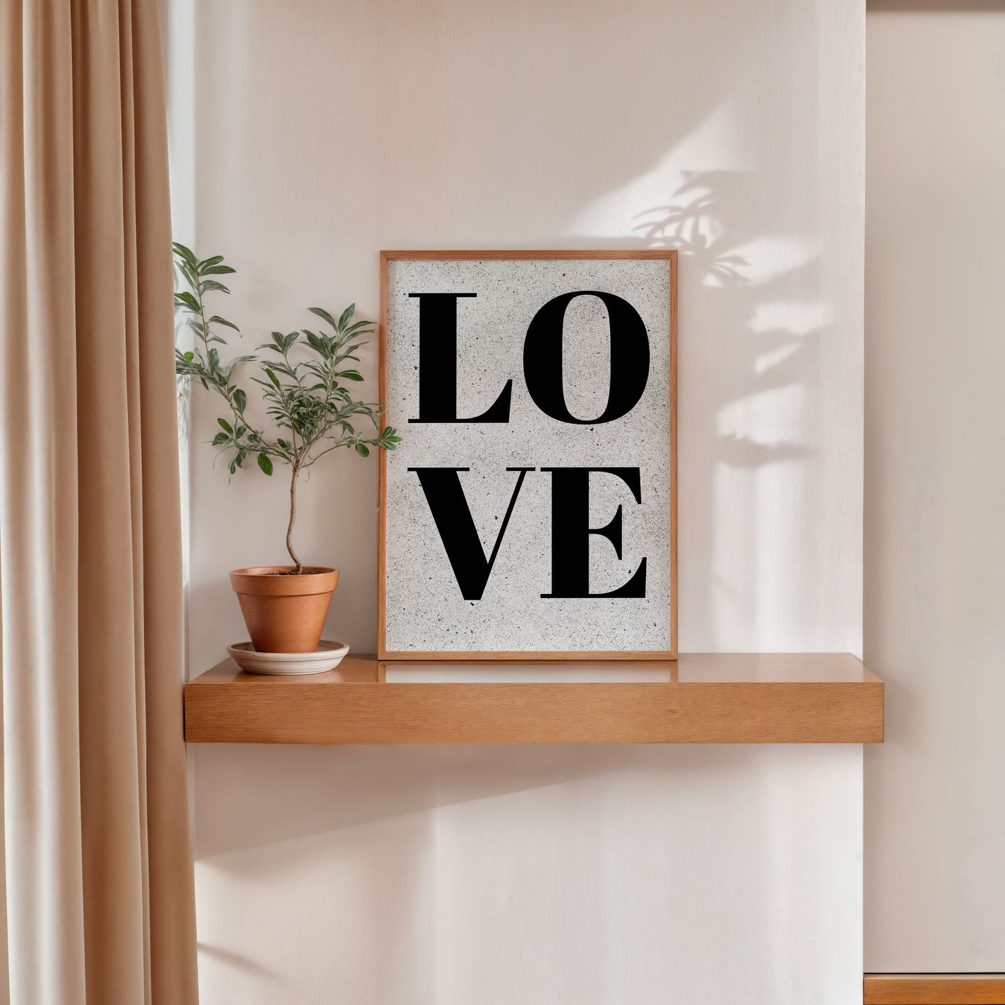 Minimalist LOVE poster in wooden frame on wall shelf with plant